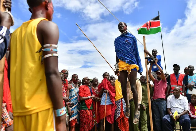 Kenyan Maasai Morans compete on December 15, 2018 the traditional high jumping during an event dubbed the Maasai Olympics at Kimana, near Kenya's bordertown with Tanzania. The olympics are an initiative of international conservation groups led by Born Free, which have been held every two years since 2012 to offer Maasai warriors an alternative to killing lions as part of their traditional rite of passage. It was the brainchild of the wildlife charity Big Life Foundation and eight Maasai elders who wanted to “stop lion hunting by our warriors once and for all”. (Photo by Tony Karumba/AFP Photo)