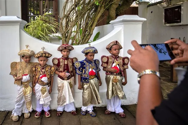 Nursery school children dressed in traditional Kandyan costumes pose for photos while they attend a cultural event as a precursor to the Esala Perahera festival on June 28, 2023 in Galle, Sri Lanka. The Esala Perahera or The Festival of the Tooth is an annual festival held in the months of July and August on the streets of Kandy with colourful processions of dancers and elephants to celebrate the Sacred Tooth Relic of the Buddha. (Photo by Abhishek Chinnappa/Getty Images)