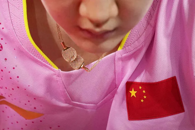 China's Chen Meng wears necklace featuring rackets during the table tennis women's singles gold medal match at the 2020 Summer Olympics, Thursday, July 29, 2021, in Tokyo. (Photo by Kin Cheung/AP Photo)