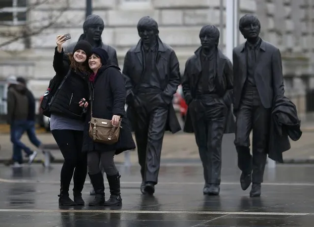 Tourists pose for a selfie in front of a statue of The Beatles  in Liverpool northern England February 8, 2016. (Photo by Phil Noble/Reuters)