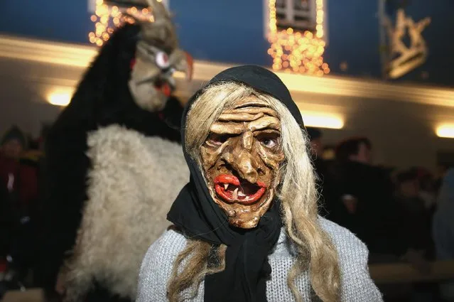 Locals dressed as “Perchten”, a traditional demonic creature in German and Austrian Alpine folklore, parade through the town center during the annual “Rauhnacht” gathering on January 5, 2017 in Waldkirchen, Germany. The “Rauhnaechte” nights are the time in between Christmas and Epiphany when winter is at its darkest and its evil spirits most prevalent. January 5, the last night before Epiphany, marks the end of the period, and in a tradition dating back to 1725 locals in Waldkirchen dressed as Perchten, witches, devils and other demonic beings parade through the streets in a final show of force before they retreat to let winter ebb. (Photo by Johannes Simon/Getty Images)