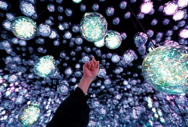 A member of the teamLab digital art group explains about an installation in preparation for the reopening of their Borderless museum in February at the Azabudai Hills complex in Tokyo, Japan on November 17, 2023. (Photo by Kim Kyung-Hoon/Reuters)