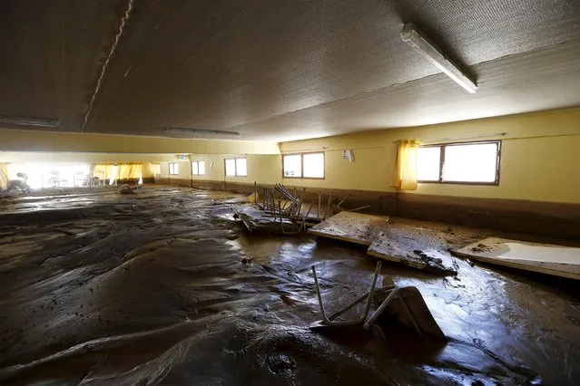 A view of a muddy saloon in a flooded warehouse in Los Loros town April 7, 2015. (Photo by Ivan Alvarado/Reuters)