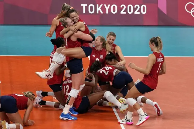 Players from the United States react after defeating Brazil to win the gold medal in women's volleyball at the 2020 Summer Olympics, Sunday, August 8, 2021, in Tokyo, Japan. (Photo by Frank Augstein/AP Photo)