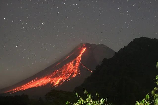 This long exposure photo taken on October 11, 2023 shows volcanic materials spewing from Mount Merapi as seen from Purwobinangun village in Sleman district, Yogyakarta, Indonesia. (Photo by Priyo Utomo/Xinhua/Alamy Live News)