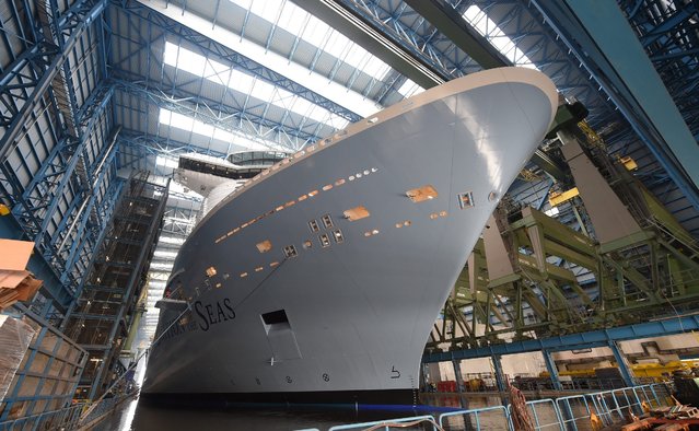 The new cruise ship “Ovation of the Seas” before being pulled out of the construction dock, at Meyer dockyard in Papenburg, Germany, 18 February 2016. The 4,180-passenger vessel was built for the US – American shipping company, Royal Caribbean. (Photo by Carmen Jaspersen/EPA)