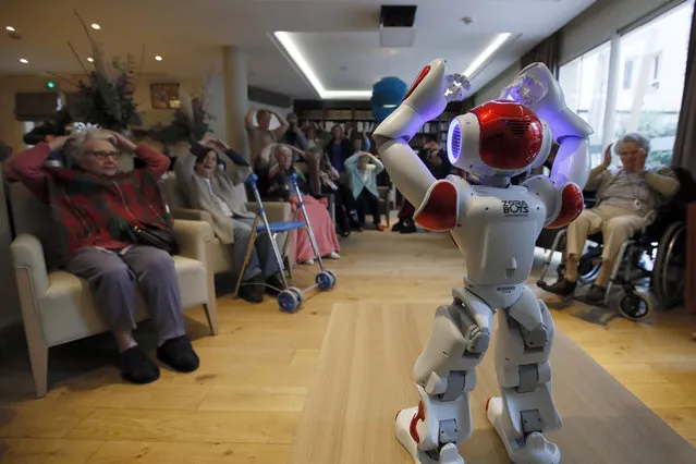 A Zora robot performs to encourage elderly people in an EHPAD (Housing Establishment for Elderly Dependant People) in Paris, Thursday, January 31, 2019. The Zora robot will promote emotional well-being by helping elderly people for exercises and manage stress through interactive technology. (Photo by Francois Mori/AP Photo)
