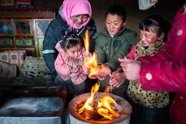 Herdswoman Qimei and her family at a resettlement site in Bange county, Tibet, China on February 1, 2019. In the past, herdsmen in Tibet endured a very long, cold winter from October to the end of June, before moving to the summer meadow. (Photo by Purbu Zhaxi/Xinhua News Agency/Barcroft Images)