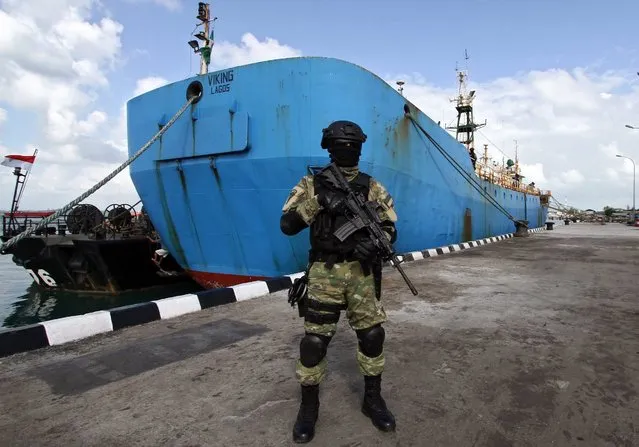 Indonesian Navy personnel stands guard in front of Nigeria-registered ship “Viking” during an inspection at Fasharkan Mentigi port, Bintan, Indonesia, 26 February 2016. The ship detained in Bintan port is subject to a purple notice issued by Interpol in September 2013 by the request of Norway. It has allegedly been involved in prohibited fishing activities, violation of international conventions and fisheries-related crimes. According to Interpol, the ship orginally named “Octopus-1” had changed its name to “Snake”, “Berber”, and presently “Viking” to avoid being detected. (Photo by Josk Omule/EPA)