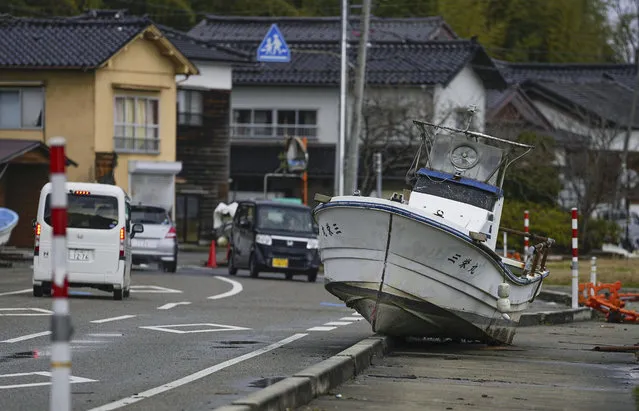 A boat is seen on the side of a road in Nanao, Ishikawa prefecture, Sunday, January 7, 2024, a week after a powerful earthquake hit western Japan. (Photo by Kyodo News via AP Photo)