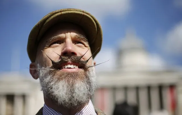 A participant models his moustache in Trafalgar Square at the start of the Tween Run in central London April 18, 2015. (Photo by Suzanne Plunkett/Reuters)