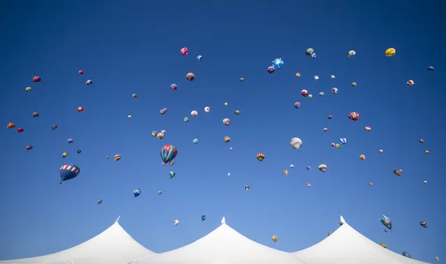 Balloons begin to take off during the Albuquerque International Balloon Fiesta Saturday, October 7, 2023 in Albuquerque, N.M. (Photo by Roberto E. Rosales/AP Photo)