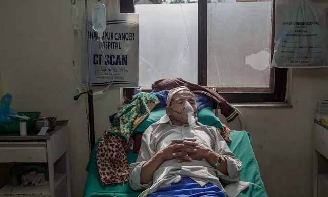 A man with lung cancer lies in a room at Bhaktapur Cancer Hospital in Bhaktapur, Nepal. Established in April 1999 by the Nepal Cancer Relief Society (NCRS), the government of Nepal, Rotary International and others, Bhaktapur Cancer Hospital is a non-profit and community-oriented hospital. It has 72 beds and employs 140 technical, ancillary and administrative staff. (Photo by Omar Havana)