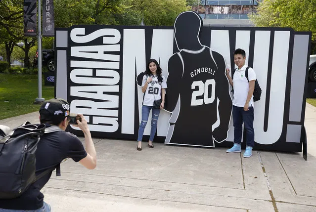 San Antonio Spurs fans pose for a photo in front of a sign thanking Spurs legend Manu Ginobili before an NBA basketball game against the Cleveland Cavaliers, Thursday, March 28, 2019, in San Antonio. Ginobili's jersey will be retired after the game. (Photo by Darren Abate/AP Photo)
