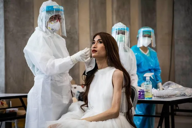 Attendants of the 22nd Miss Universe Thailand pageant receive a mandatory COVID-19 rapid test before entering the event at Nong Nooch Tropical Garden on October 24, 2021 in Pattaya, Thailand. The annual pageant, held at a botanical garden this year, determines the Thai representative for the global Miss Universe competition. Social distancing measures are in place with pre-event COVID-19 testing required for all attendees. (Photo by Lauren DeCicca/Getty Images)