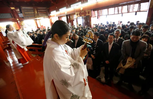Shinto maidens tinkle bells during a ceremony for companies wishing for prosperous business in front of an altar at the start of the new business year at Kanda Myojin Shrine, which is known to be frequented by worshippers seeking good luck and prosperous businesses, in Tokyo, Japan, January 4, 2017. (Photo by Toru Hanai/Reuters)
