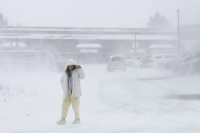 A person walks at a shopping center under heavy snowfall in Mammoth Lakes, California, USA, 01 March 2024. The National Weather Service (NWS) issued a blizzard warning for Mono County until 03 March. The NWS expects winds gusting as high as 70 miles per hour in the lower elevations and above 100 miles per hour over the Sierra ridges. (Photo by Caroline Brehman/EPA/EFE/Rex Features/Shutterstock)