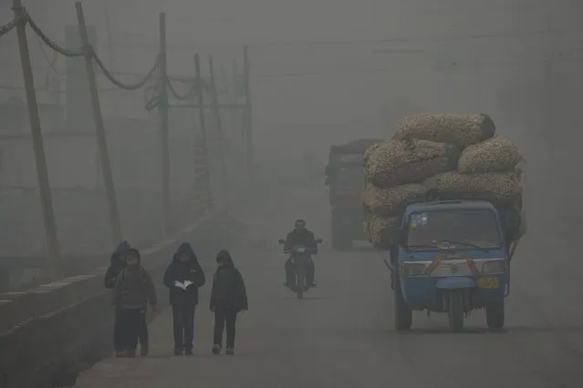 Children walk back home after school on a severely polluted day in Shijiazhuang, in northern China's Hebei province, Wednesday, February 26, 2014. (Photo by Alexander F. Yuan/AP Photo)