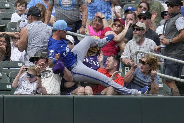 Kansas City Royals third baseman Nick Loftin crashes into the netting and the first row of fans as he failed to make a play on a foul ball hit by Colorado Rockies' Nolan Jones during the second inning of a spring training baseball game Tuesday, March 12, 2024, in Scottsdale, Ariz. (Photo by Ross D. Franklin/AP Photo)