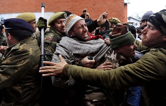 Jammu and Kashmir government employees scuffle with policemen during a protest in Srinagar, on February 22, 2014. Indian police detained dozens of government employees demanding payment of arrears in salaries and raising of the retirement age, among other demands. (Photo by Dar Yasin/Associated Press)