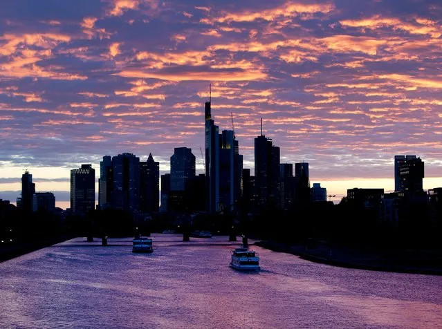 Ships pass by on the river Main after the sun set in Frankfurt, Germany, Wednesday, May 15, 2019. (Photo by Michael Probst/AP Photo)