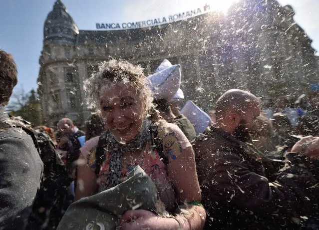 People fight with pillows on “World Pillow Fight Day” downtown Bucharest April 2, 2016. The Pillow Fight Day attracts tens of thousands people in more than 100 cities all over the World each year. (Photo by Daniel Mihailescu/AFP Photo)