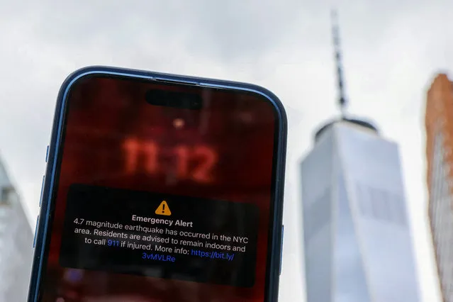 A photo illustration shows an emergency alert of a magnitude 4.7 earthquake on a cellphone in New York City, U.S., April 5, 2024. (Photo by Andrew Kelly/Illustration via Reuters)