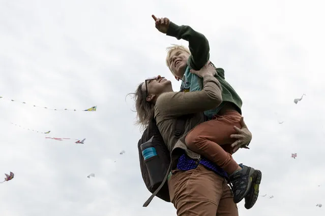 Sarah Brown and her son Gavin Brown, 5, look up at the kites during the annual Blossom Kite Festival on the National Mall in Washington, D.C. on March 30, 2024.(Amanda Andrade-Rhoades for The Washington Post)