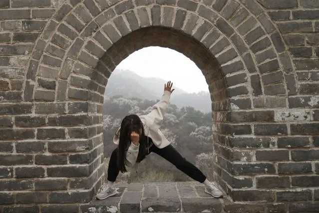 A woman poses for a photo at the Badaling Great Wall of China on the outskirts of Beijing, Saturday, April 13, 2024. (Photo by Tatan Syuflana/AP Photo)