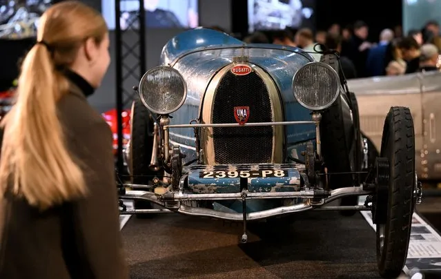 A visitor looks at a Bugatti T37 during the 47th edition of Retromobile, the international Classic Cars exhibition at Paris Expo Porte de Versailles in Paris on January 31, 2023. Retromobile, which offers visitors the opportunity to discover or rediscover outstanding car models and collections, will be held from February 1 to 5, 2023. (Photo by Emmanuel Dunand/AFP Photo)