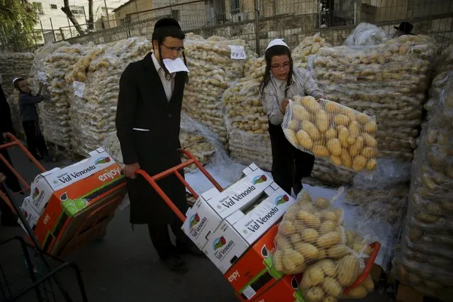 Ultra-Orthodox Jewish youths collect food during a distribution of food for families for the upcoming Jewish holiday of Passover near Jerusalem's Mea Shearim neighbourhood April 19, 2016. (Photo by Ronen Zvulun/Reuters)