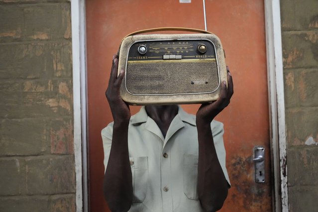 Ngwiza Khumbulani Moyo, a vintage collector holds an old radio set outside his home in Bulawayo, Wednesday, February 15, 2023. According to a survey by Afrobarometer, radio is “overwhelmingly” the most common source of news in Africa. About 68% of respondents said they tune in at least a few times a week, compared to about 40% who said they use social media and the internet. (Photo by Tsvangirayi Mukwazhi/AP Photo)