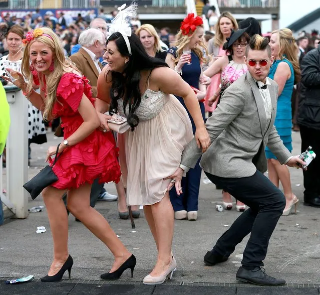 Racegoers pose for a photo during Ladies Day of the Crabbie's Grand National 2014 Festival at Aintree Racecourse, Liverpool, on April 4, 2014. (Photo by David Davies/PA Wire)