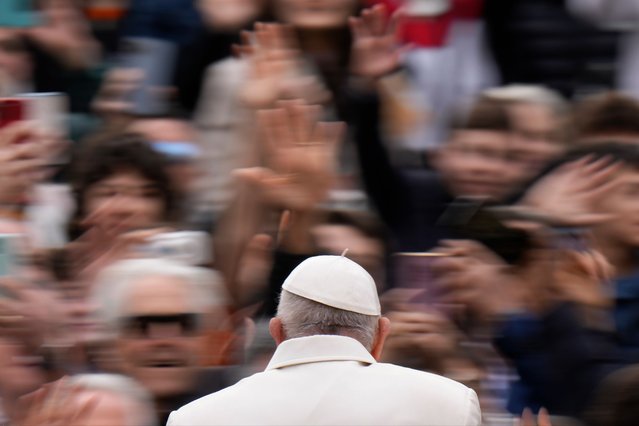 Pope Francis waves faithful as he arrives for his weekly general audience in St. Peter's Square, at the Vatican, Wednesday, April 3, 2024. (Photo by Alessandra Tarantino/AP Photo)