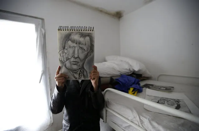 Farhad Nouri poses with a portrait of German Chancellor Angela Merkel in his room in the “Krnjaca” collective centre near Belgrade, Serbia, Monday, March 13, 2017. A 10-year-old boy from Afghanistan is known as Little Picasso among migrants in a Serbia asylum camp because of his artistic talent. Nouri, his parents and two younger brothers hope to move to Switzerland or the United States, but have been stuck in the Balkan country for months unable to cross the heavily guarded borders of the European Union. (Photo by Darko Vojinovic/AP Photo)