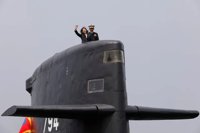 Taiwan President Tsai Ing-wen waves as she boards Hai Lung-class submarine (SS-794) during her visit to a navy base in Kaohsiung, Taiwan March 21, 2017. Tsai talks about the plan of manufacturing submarines domestically in a bid to enhance Taiwan's defense capabilities. (Photo by Tyrone Siu/Reuters)