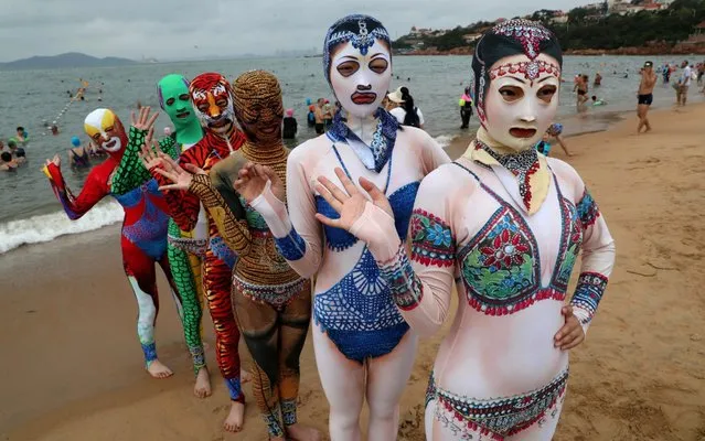 Models wearing facekinis, popular with female bathers who want to protect more than just their modesty, pose for a picture on a beach on August 5, 2019 in the Chinese seaside city of Qingdao, Shandong Province of China. (Photo by Xu Chongde/VCG via Getty Images)