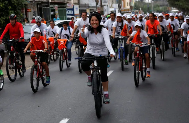 Peruvian presidential candidate Keiko Fujimori of the Fuerza Popular (Popular Force) party rides a bicycle during a campaign rally at Surco district in Lima, Peru April 30, 2016. (Photo by Janine Costa/Reuters)