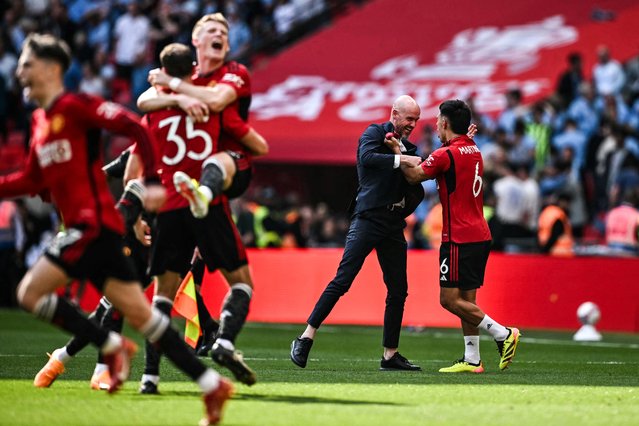 Manchester United's Dutch manager Erik ten Hag (C) celebrates with his players after winning the English FA Cup final football match between Manchester City and Manchester United at Wembley stadium, in London, on May 25, 2024. Manchester United wins 2-1 against Manchester City. (Photo by Ben Stansall/AFP Photo)