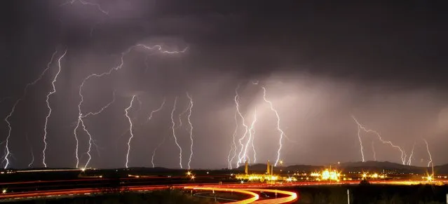 Mass lightning bolts light up night skies by Daggett airport from monsoon storms passing over the high deserts early Wednesday, north of Barstow, California, July 1, 2015. Picture taken using long exposure. (Photo by Gene Blevins/Reuters)