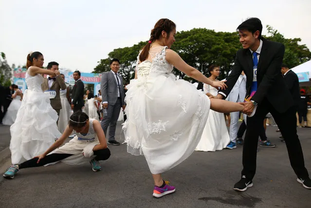 Couples participate in the “Running of the Brides” race in a park in Bangkok, Thailand March 25, 2017. (Photo by Athit Perawongmetha/Reuters)