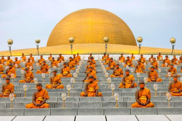 Buddhist monks attend the Makha Bucha celebrations at Wat Dhammakaya temple in Pathum Thani province, north of Bangkok on February 16, 2022. (Photo by Jack Taylor/AFP Photo)