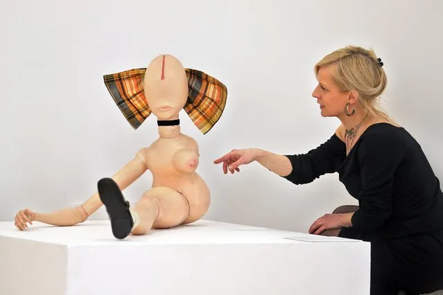 A member of the Kunstverein art association points to the puppet “La Demi-Poupee” (1971) by German artist Hans Bellmer during a press meeting for the exhibition “Puppets in the Classic Modern” at the Kunstverein Talstrasse e.V. in Halle/Saale, Germany, 22 April 2014. The exhibition kicks off on the opening weekend of the new Arts Hall of the Kunstverein, a 360 square meters large extension building that cost 1.5 million euros, from 25 to 27 April. (Photo by Jan Woitas/EPA)