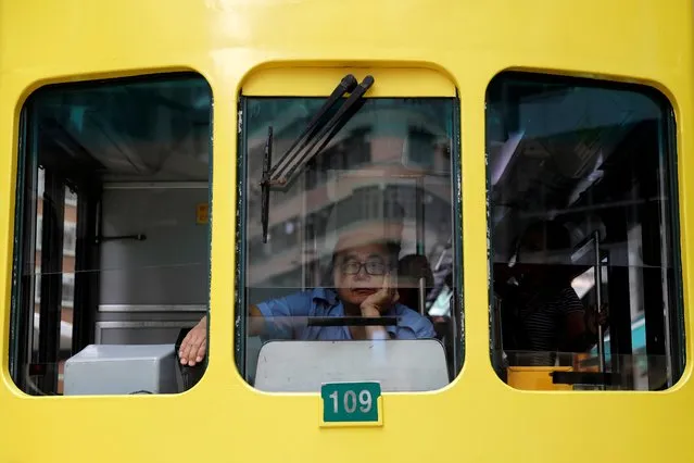 A man sits inside a light rail at Wan Chai neighborhood in Hong Kong, China, August 23, 2019. (Photo by Willy Kurniawan/Reuters)