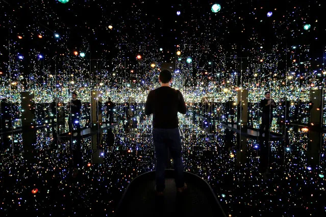 A man views the exhibit “Infinity Mirrored Room – The Souls of a Million Light Years Away” by Japanese artist Yayoi Kusama at the Hirshhorn Museum in Washington, U.S., April 25, 2017. (Photo by Joshua Roberts/Reuters)
