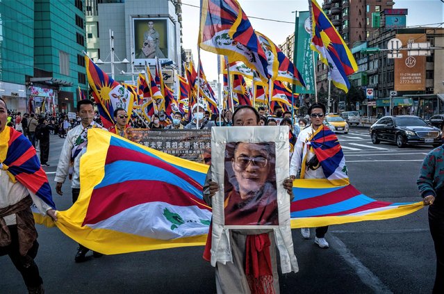 Man hold picture of Dalai Lama as Tibetans and Taiwanese who support Tibetan freedom protest on the streets of Taipei, Taiwan on March 5, 2023 on the 64th anniversary of the uprising in Tibet. Protesters demand that Chinese authorities stop repressing people in Tibet and that the Dalai Lama return to Lhasa. (Photo by Wiktor Dabkowski/ZUMA Press Wire/Rex Features/Shutterstock)