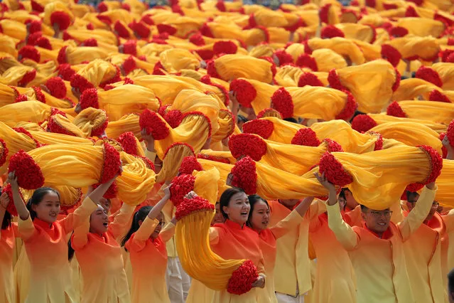 Participants march during the celebration to commemorate the 70th anniversary of the founding of Communist China in Beijing, Tuesday, October 1, 2019. (Photo by Ng Han Guan/AP Photo)