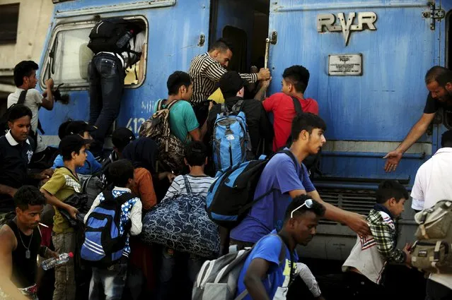 Migrants try to get onboard an overloaded train at Gevgelija train station in Macedonia, near the border with Greece, on their transit route to Europe, July 19, 2015. The European Union failed to reach a deal to resolve a migration crisis in the Mediterranean, and instead set a deadline of July 20 to reach an agreement on how to redistribute 40,000 asylum seekers currently in Italy and Greece. (Photo by Ognen Teofilovski/Reuters)