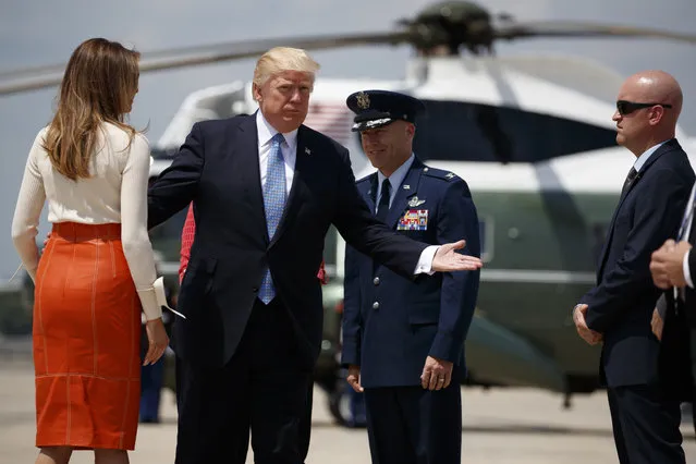 President Donald Trump and first lady Melania Trump with Col. Casey D. Eaton, Commander, 89th Airlift Wing, Andrews Air Force Base prepares to board Air Force One at Andrews Air Force Base, Md., Friday, May 19, 2017, for his first international trip as president (Photo by Evan Vucci/AP Photo)