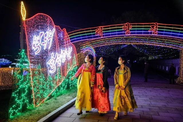 In this photo taken on April 14, 2022, people visit the Light Festival to celebrate the 110th birth anniversary of late North Korean leader Kim Il Sung at Kim Il Sung Square in Pyongyang. (Photo by Kim Won Jin/AFP Photo)